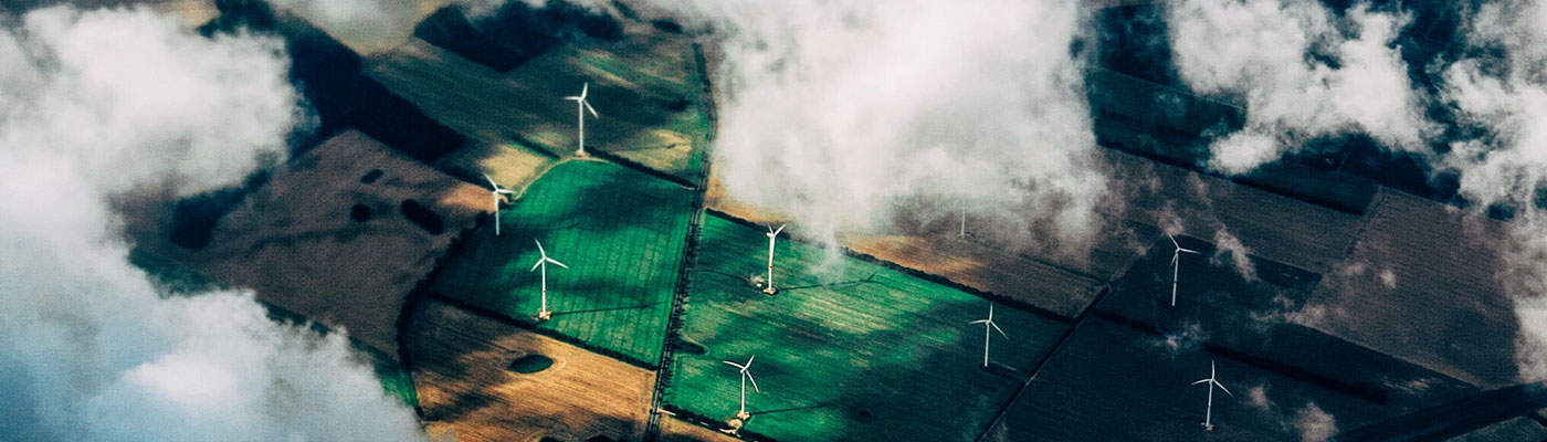 aerial view of farmland with wind turbines